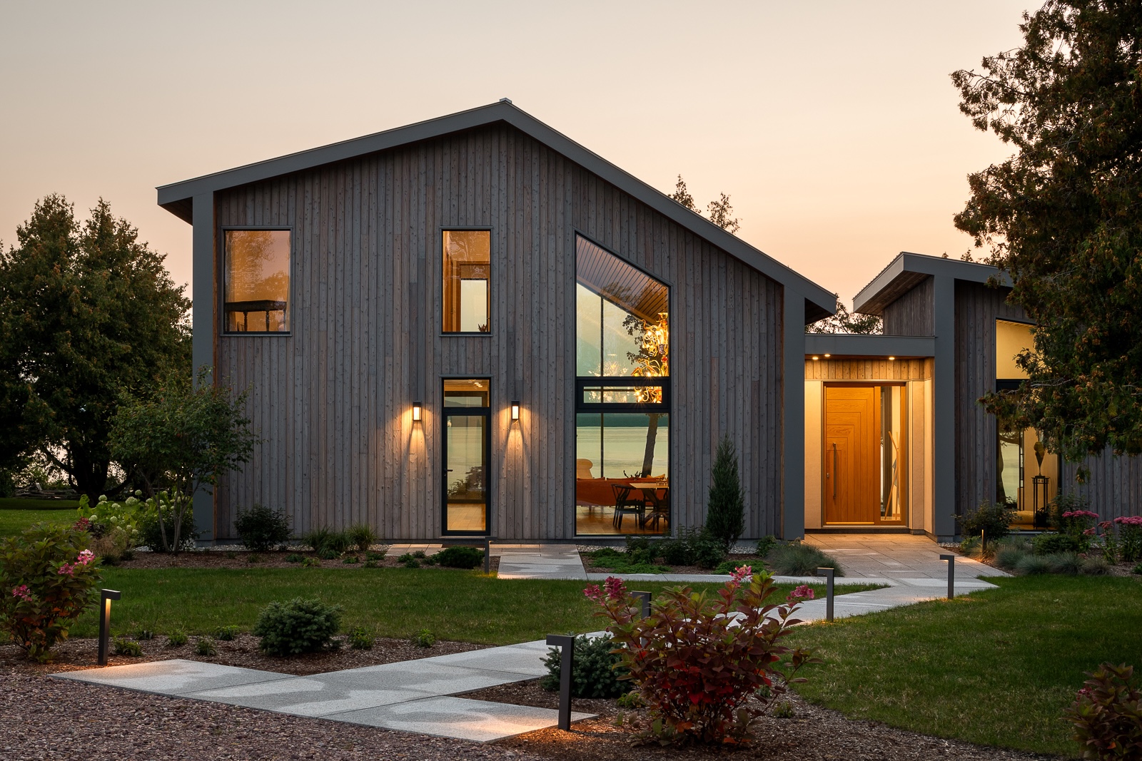 Pika-Pika Linseed gray and brown shou sugi ban paneling on modern lake house exterior